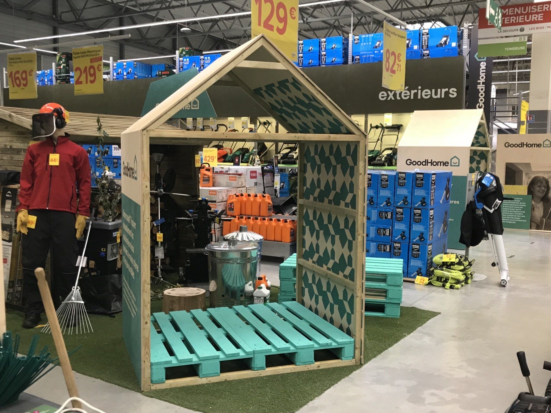 A small wooden house made out of pallets in a store.