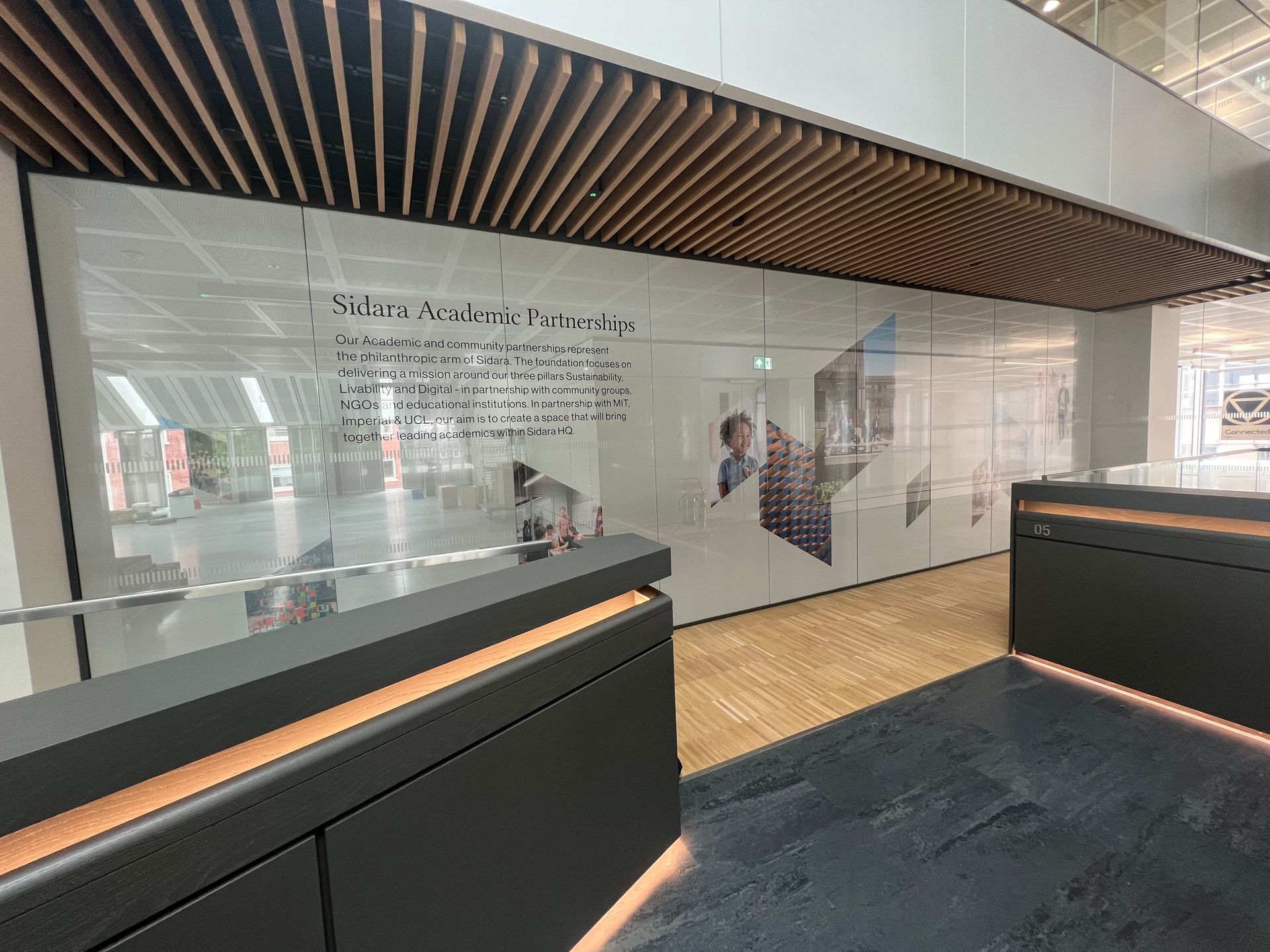 A large room with a glass wall and a wooden ceiling.
