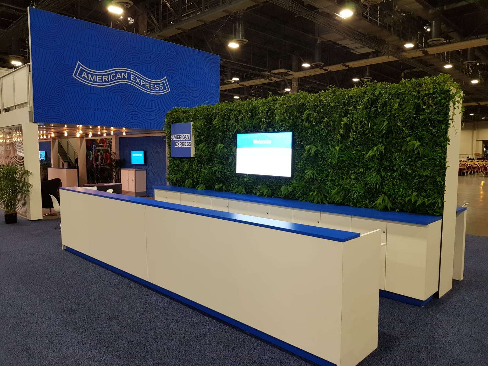 A blue and white booth with a green wall behind it