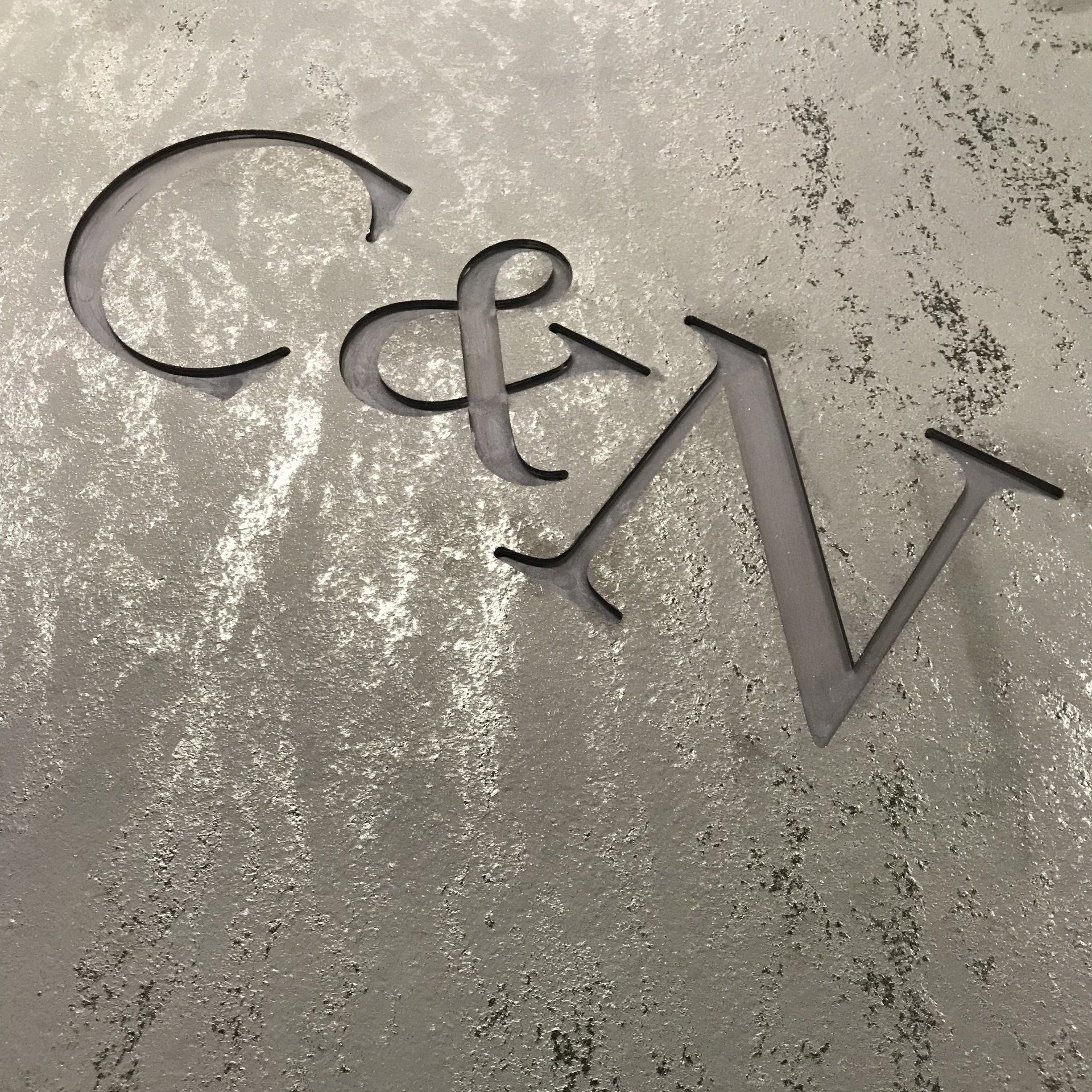 The letters c and v are cut out of a piece of paper