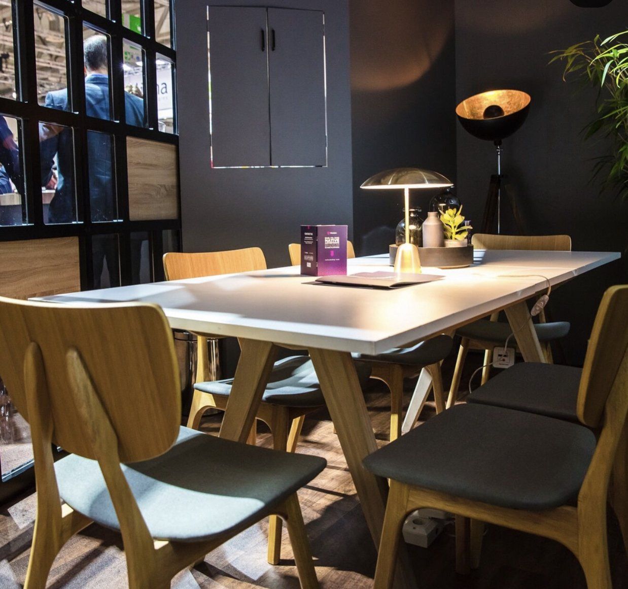 A dining room with a table and chairs and a lamp