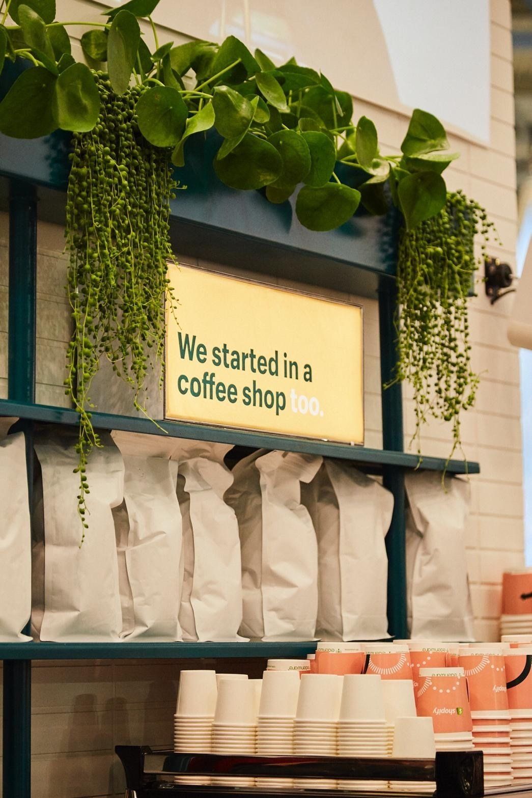 A coffee shop with a sign that says `` we started in a coffee shop ''.