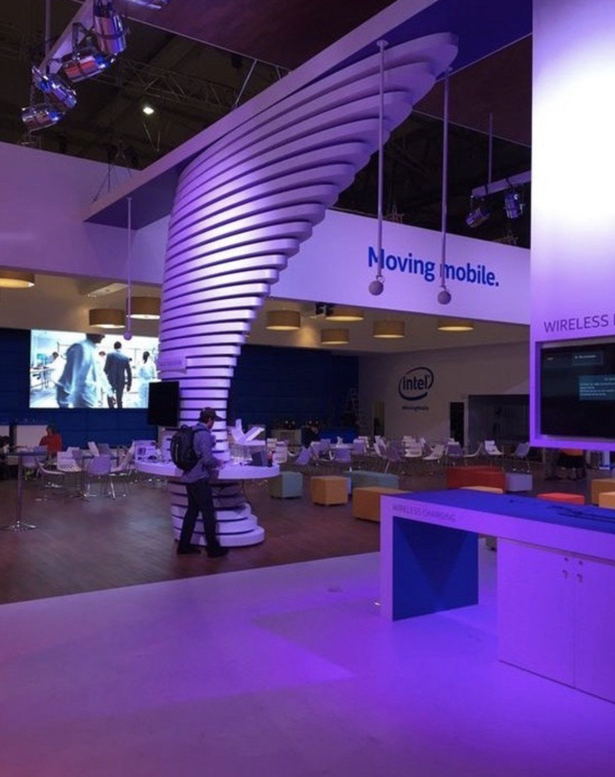 A man standing in a room with a sign that says moving mobile