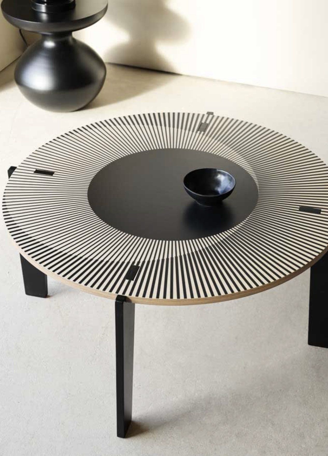 A black and white table with a bowl on it