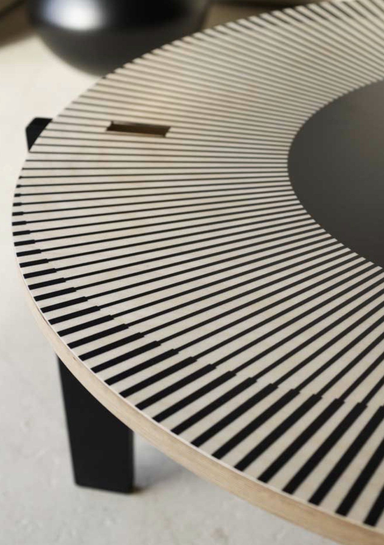 A round table with black and white stripes on it