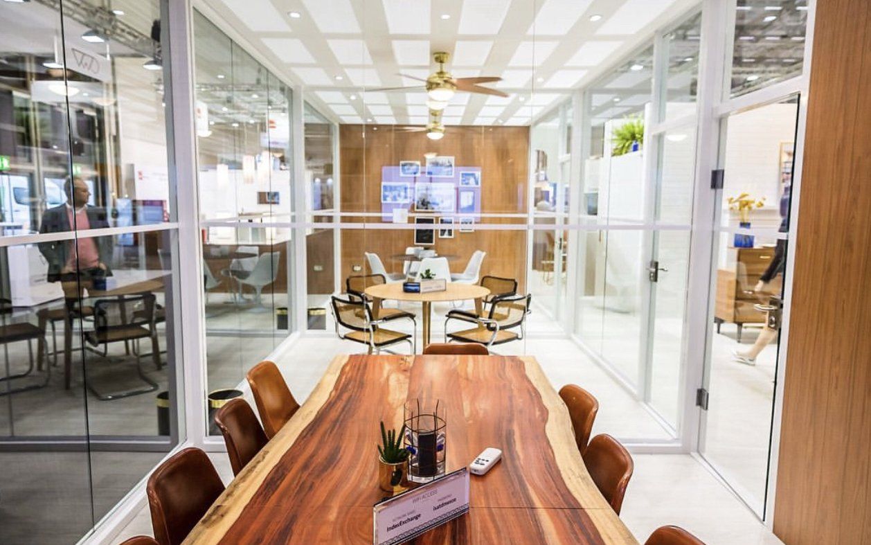A conference room with a large wooden table and chairs.