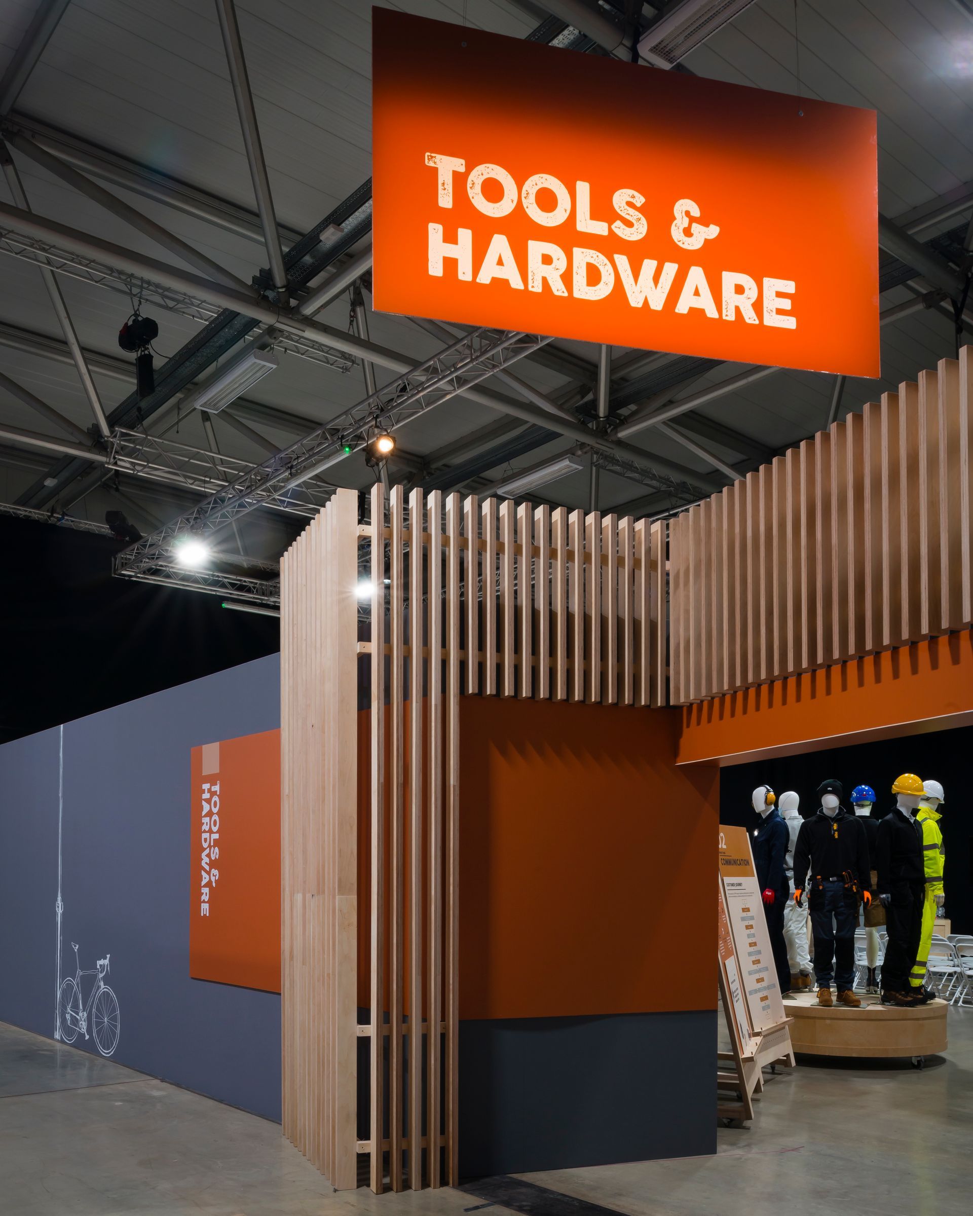 A sign for tools and hardware hangs from the ceiling