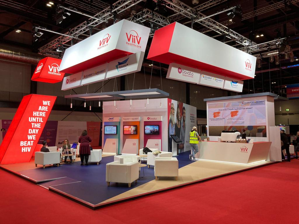 A large red and white display with chairs and tables in a room.