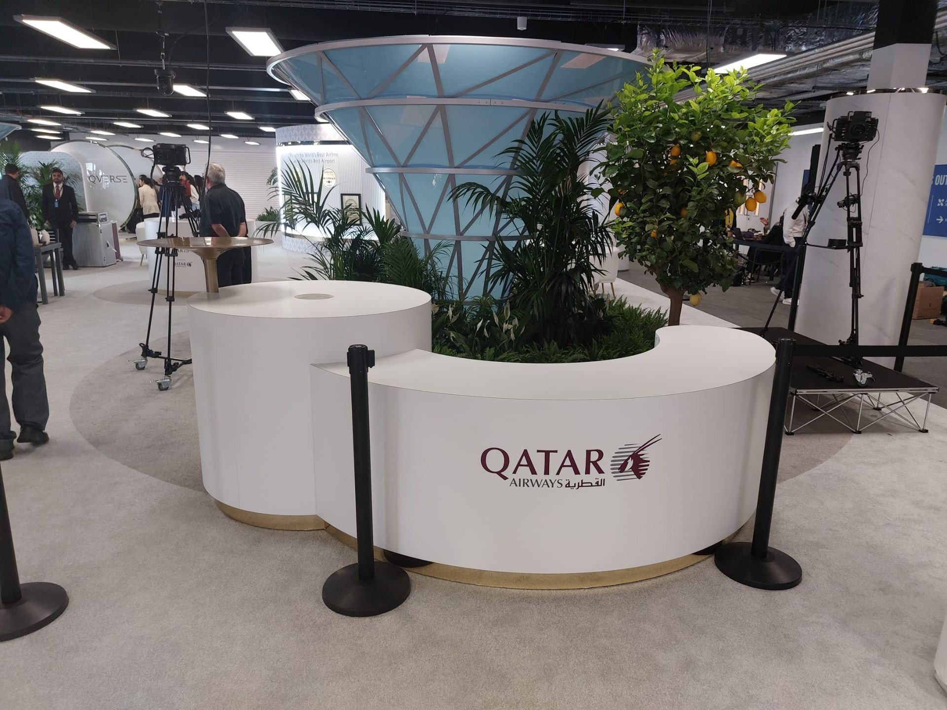 A white planter with the word qatar on it