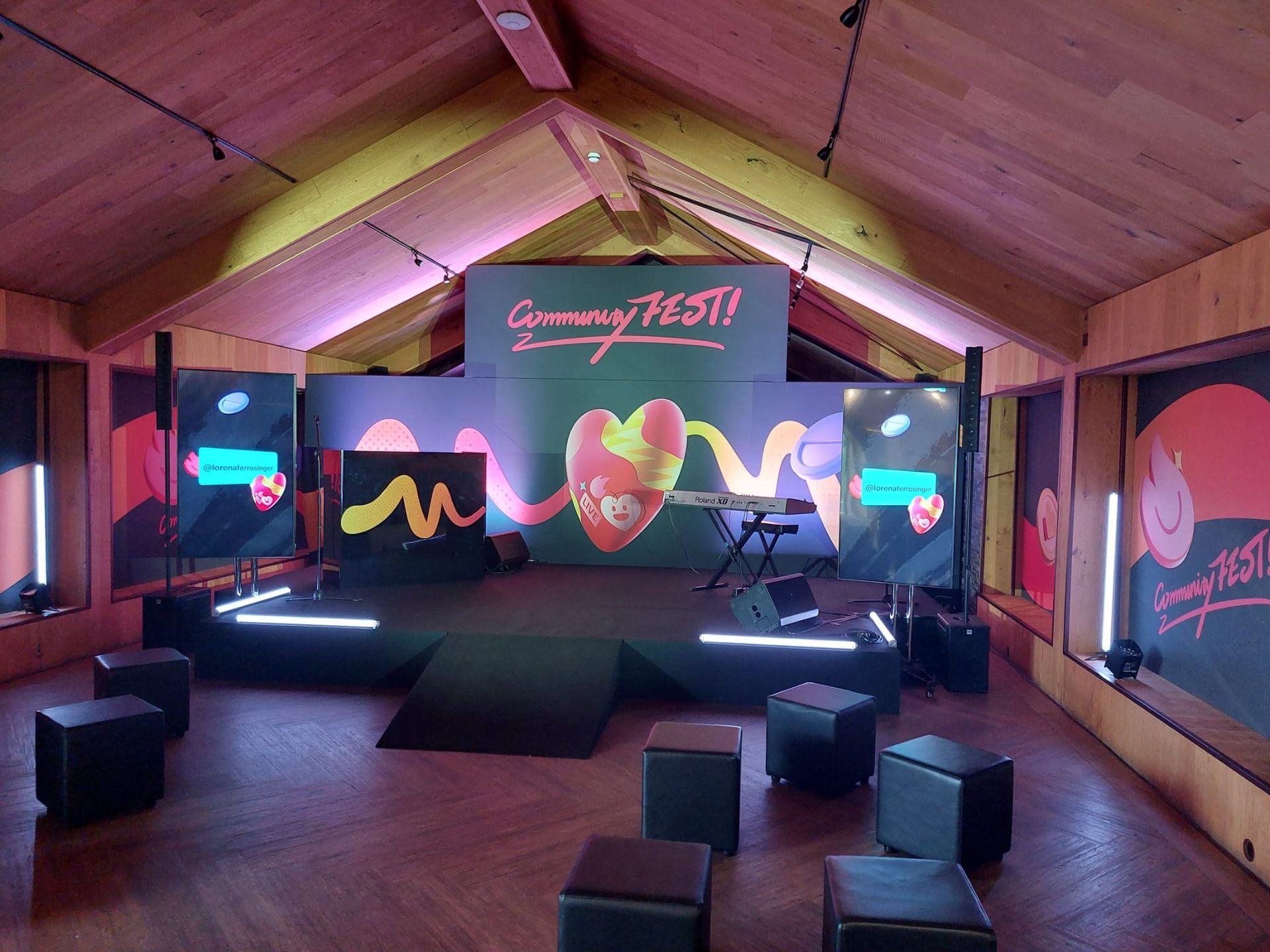 A large room with a stage and a sign that says gummy fest