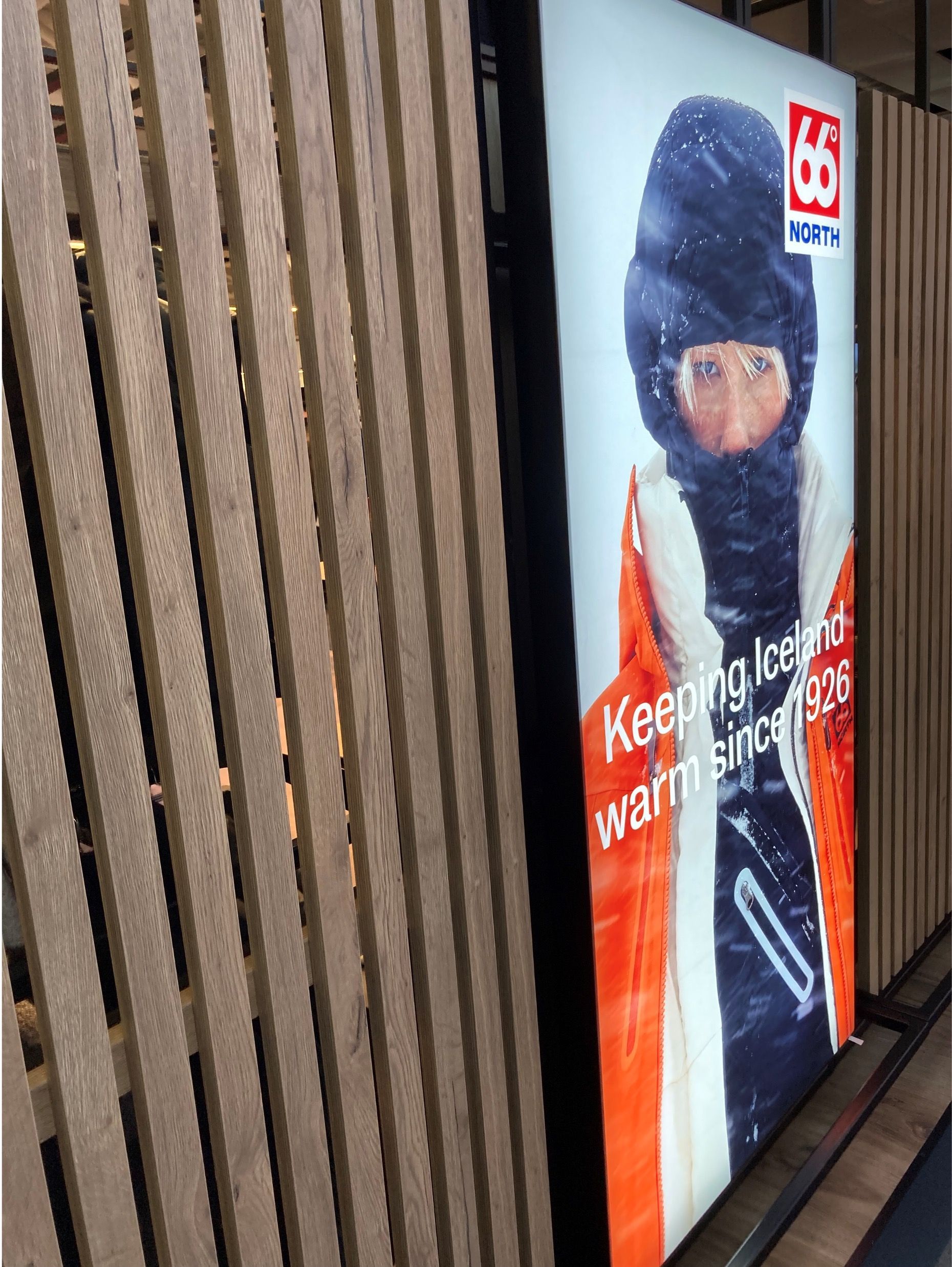 A picture of a person wearing a ski mask is on a wall.