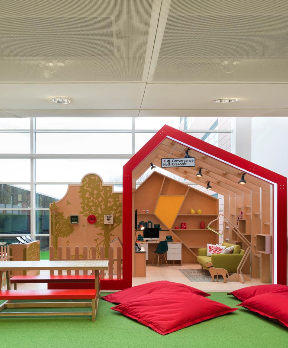 A room with red pillows and a sign that says ' a ' on it