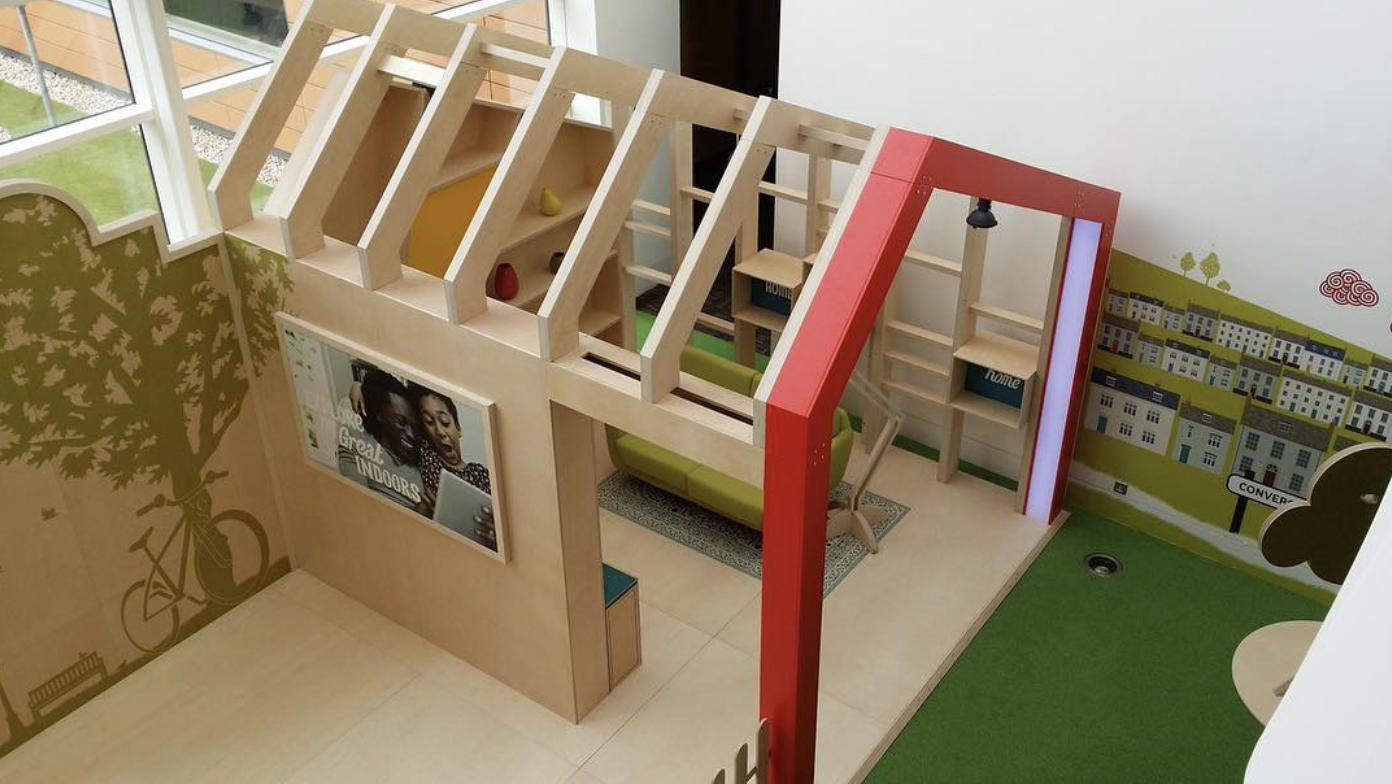 An aerial view of a wooden playhouse in a room.