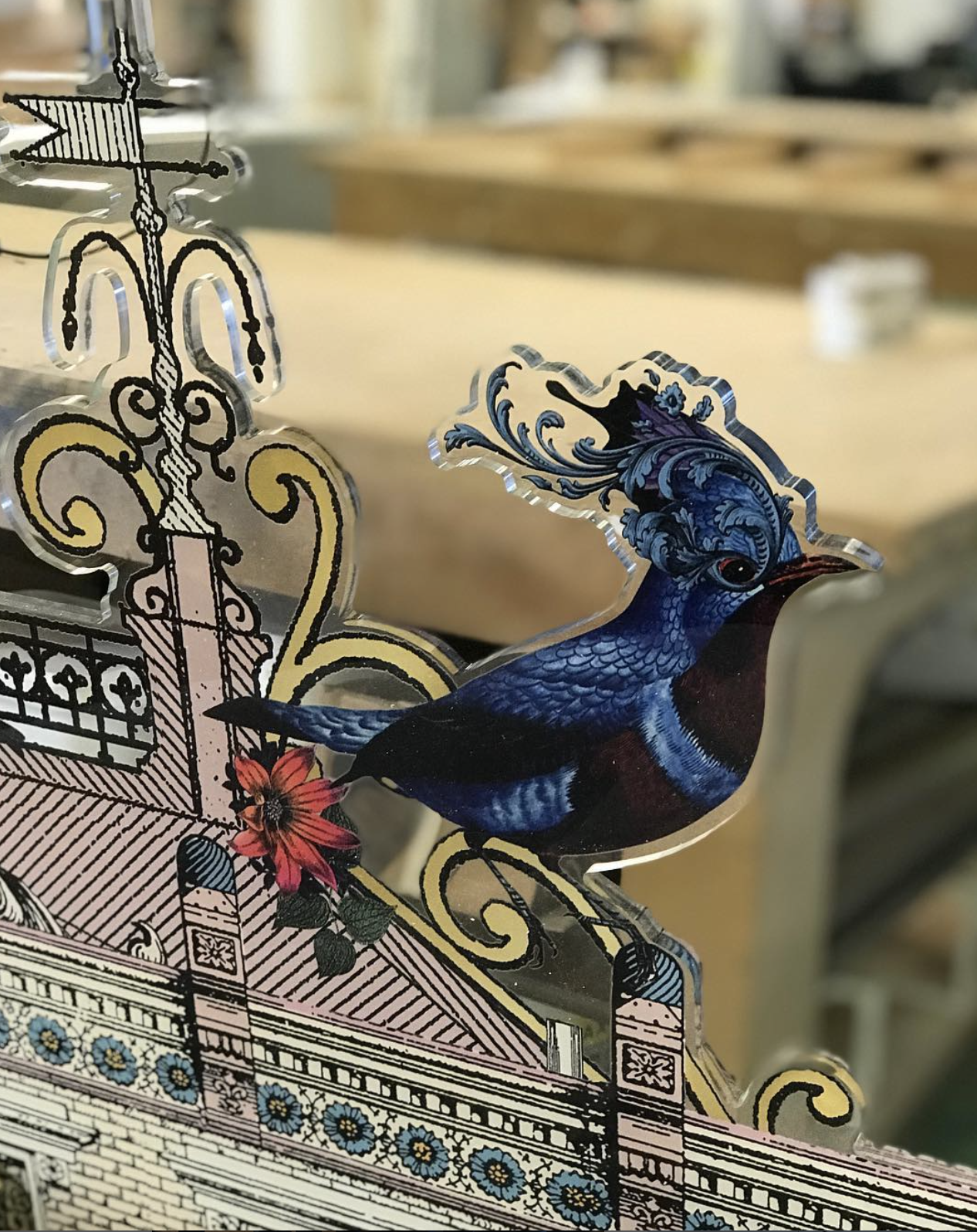 A blue bird is sitting on top of a piece of paper.