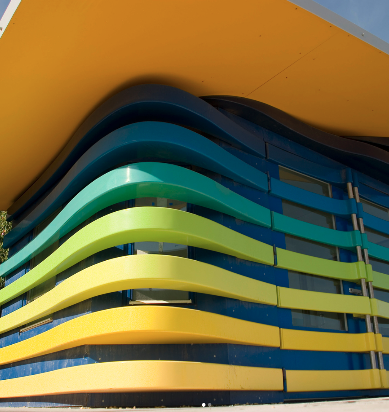 A building with blue green and yellow stripes on it