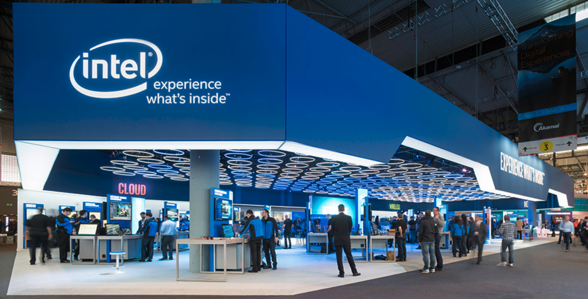 A group of people are standing in front of an intel booth