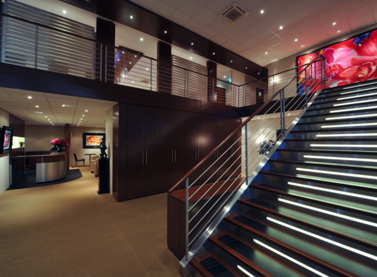 A lobby with stairs leading up to the second floor