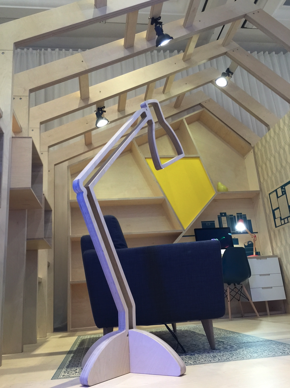 A room with a chair and a lamp with a yellow shade