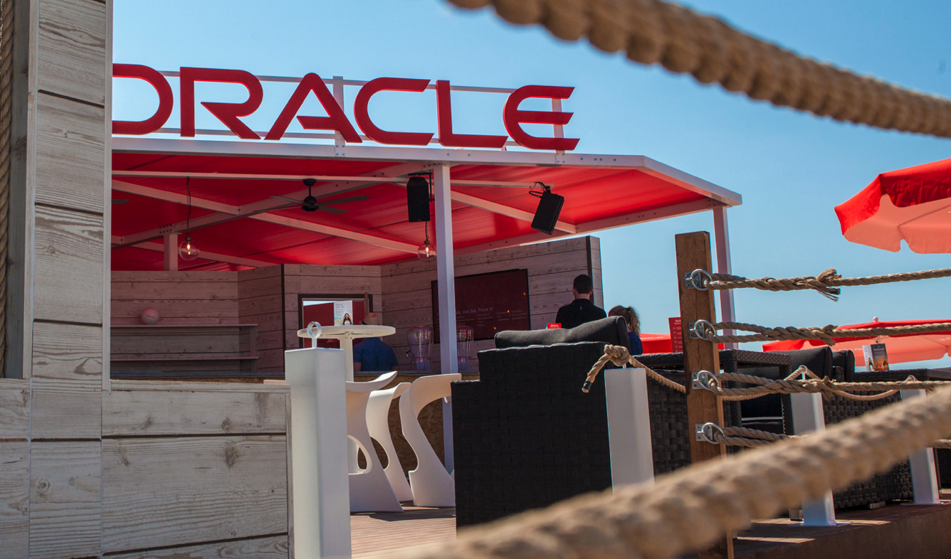 A restaurant with a red awning that says oracle