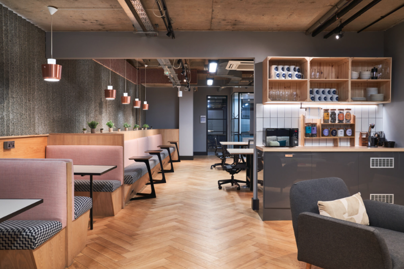 A room with a lot of tables and chairs in it