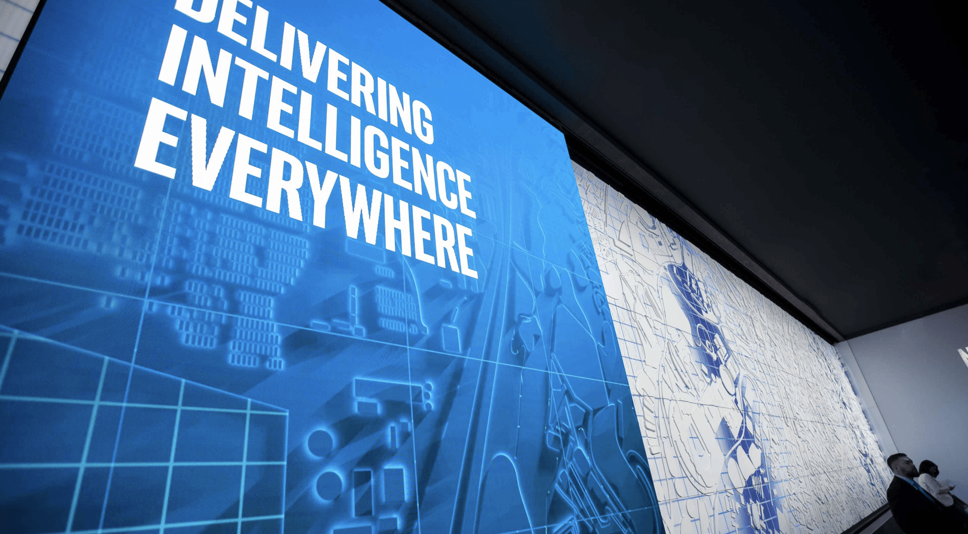 A large blue sign that says delivering intelligence everywhere