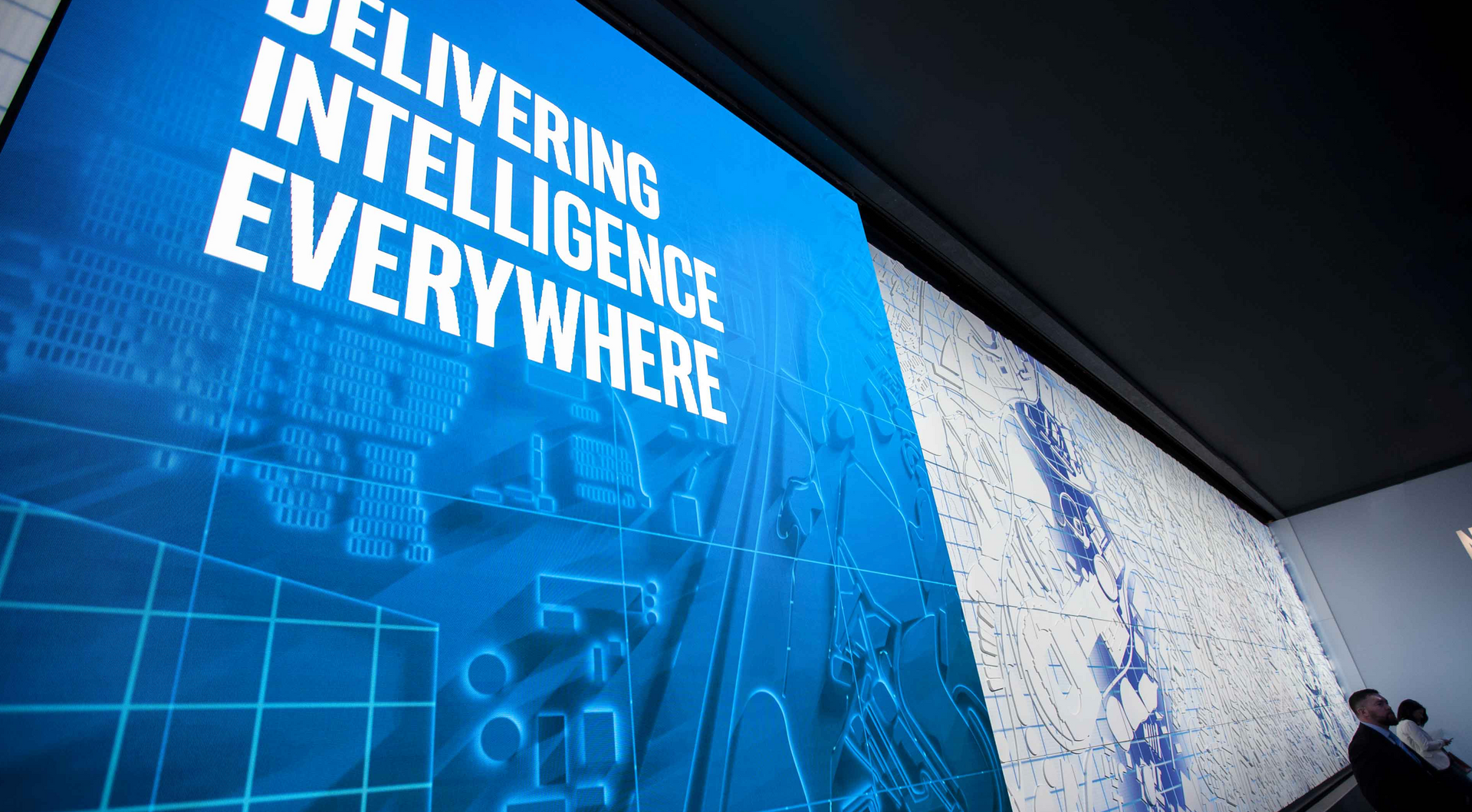 A large blue sign that says delivering intelligence everywhere