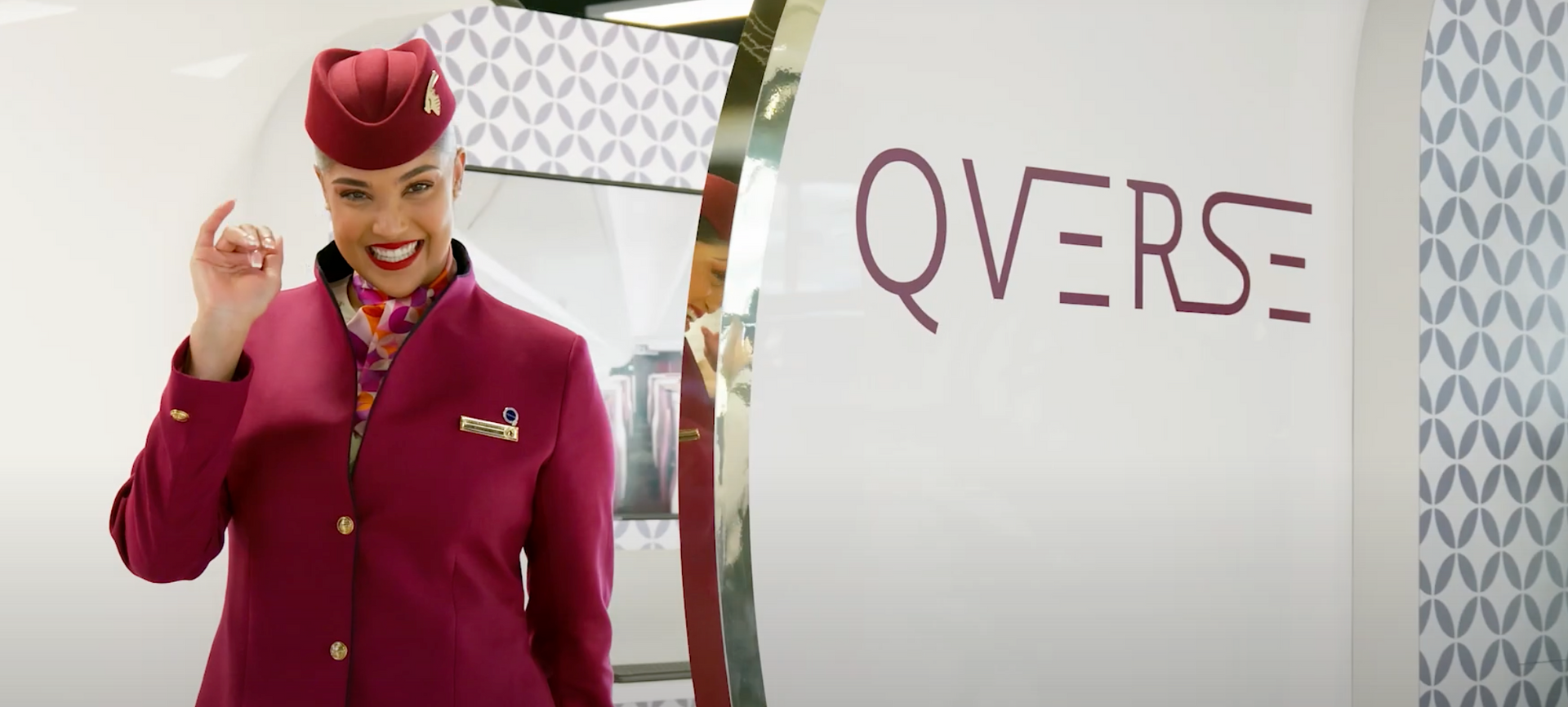 A flight attendant is standing in front of a sign that says overse.