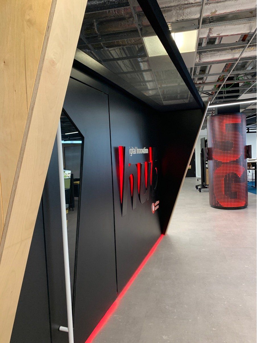 A black wall with a red stripe on the bottom