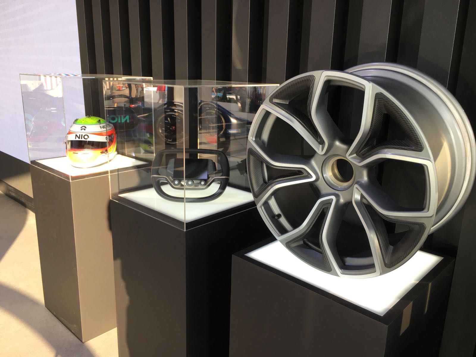 A car wheel is on display in a glass case
