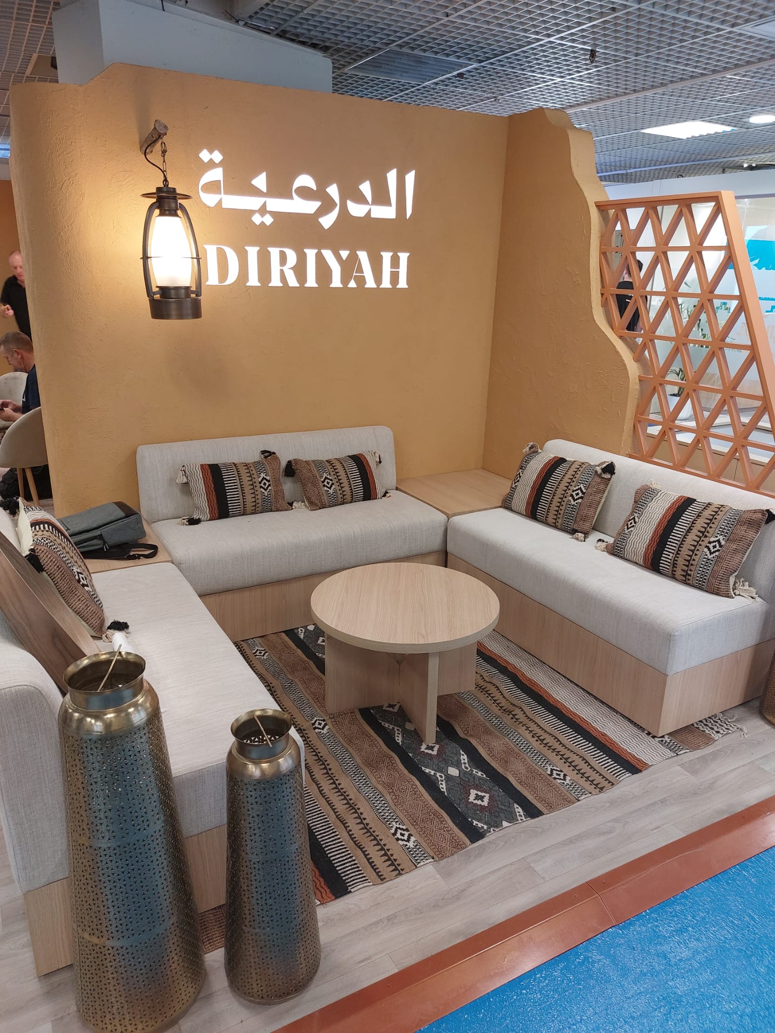 A living room with a couch , table and vases.
