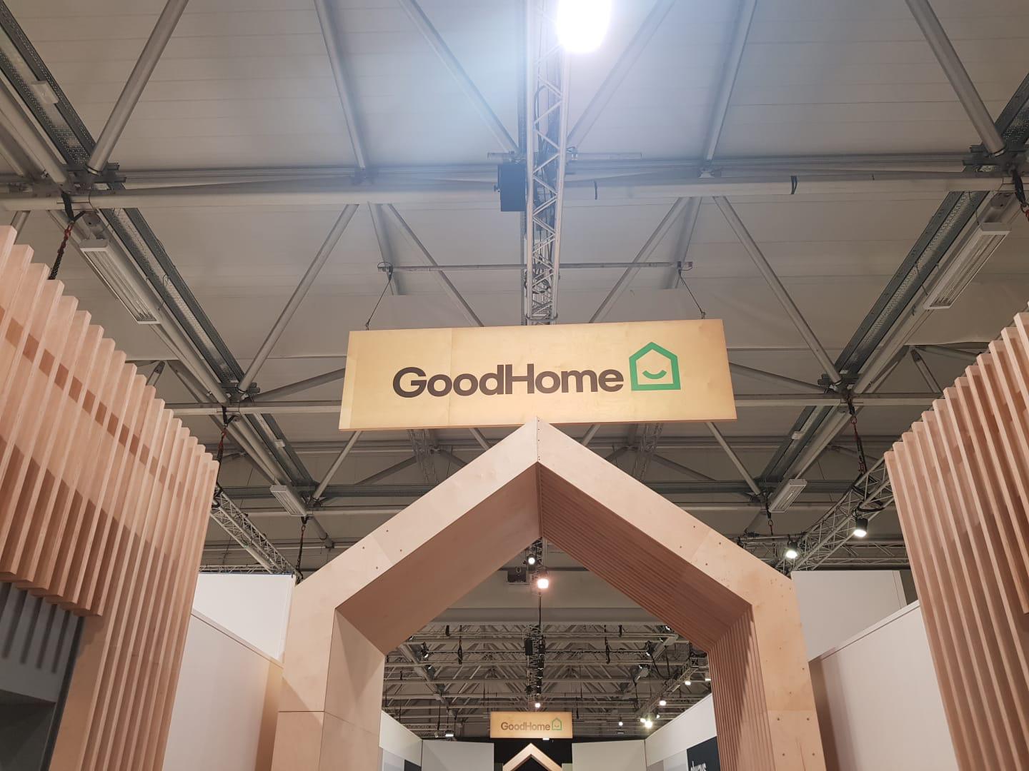 A good home sign hangs from the ceiling of a building