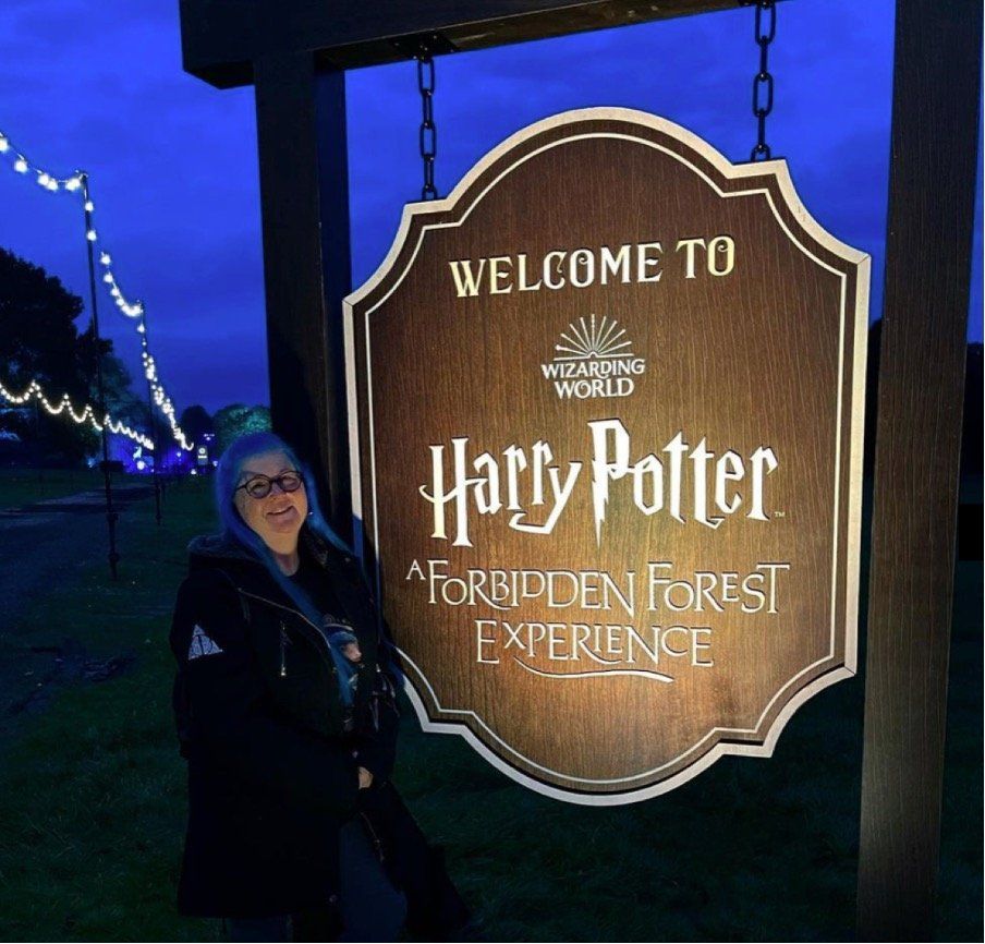 A woman stands in front of a harry potter sign
