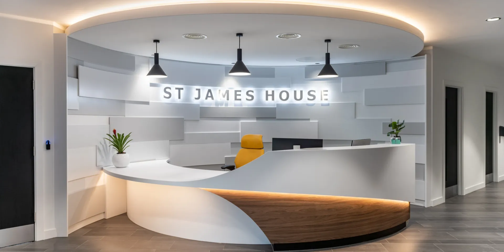 A reception area with a round counter and a sign that says st james house.