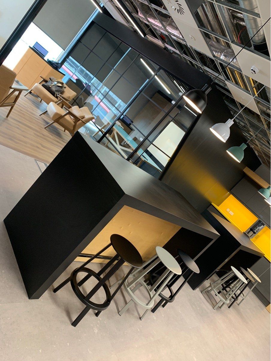 A room with a table and stools in it