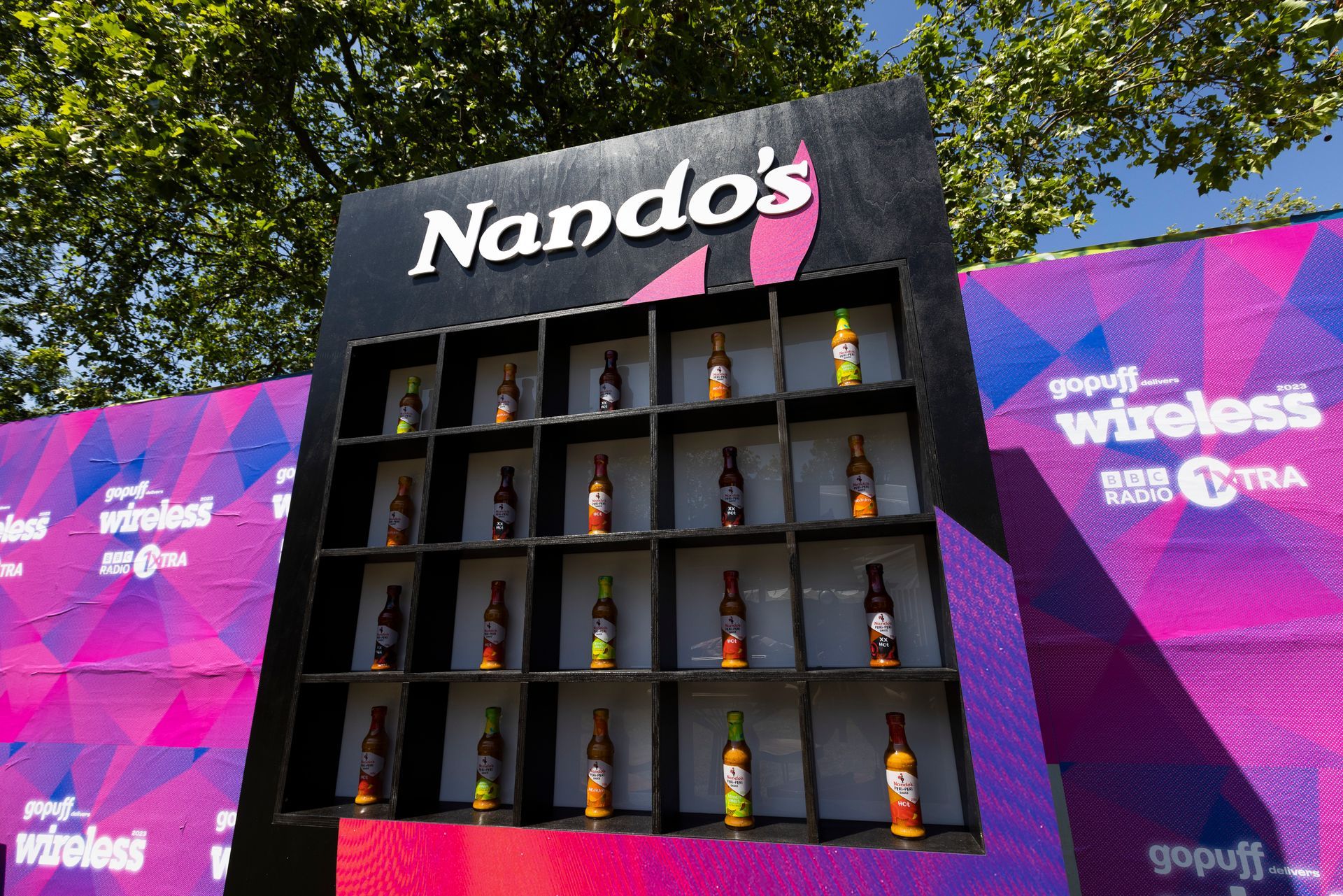 A nando 's sign with bottles on it