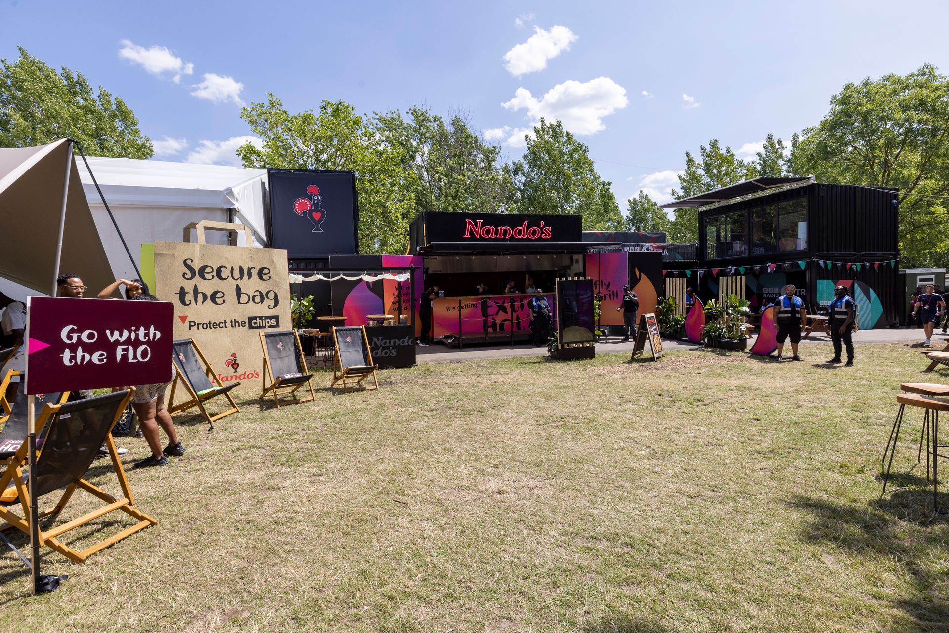 A group of people standing in a field with a sign that says `` go with the pig ''.