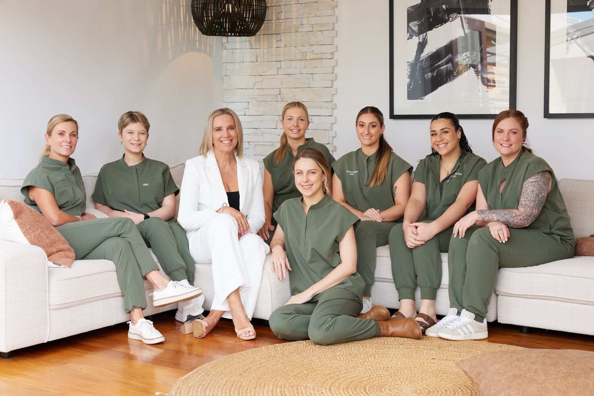 A Woman Wearing Apron Is Standing in A Hallway To Welcome — Figtree Day Spa in Sawtell, NSW