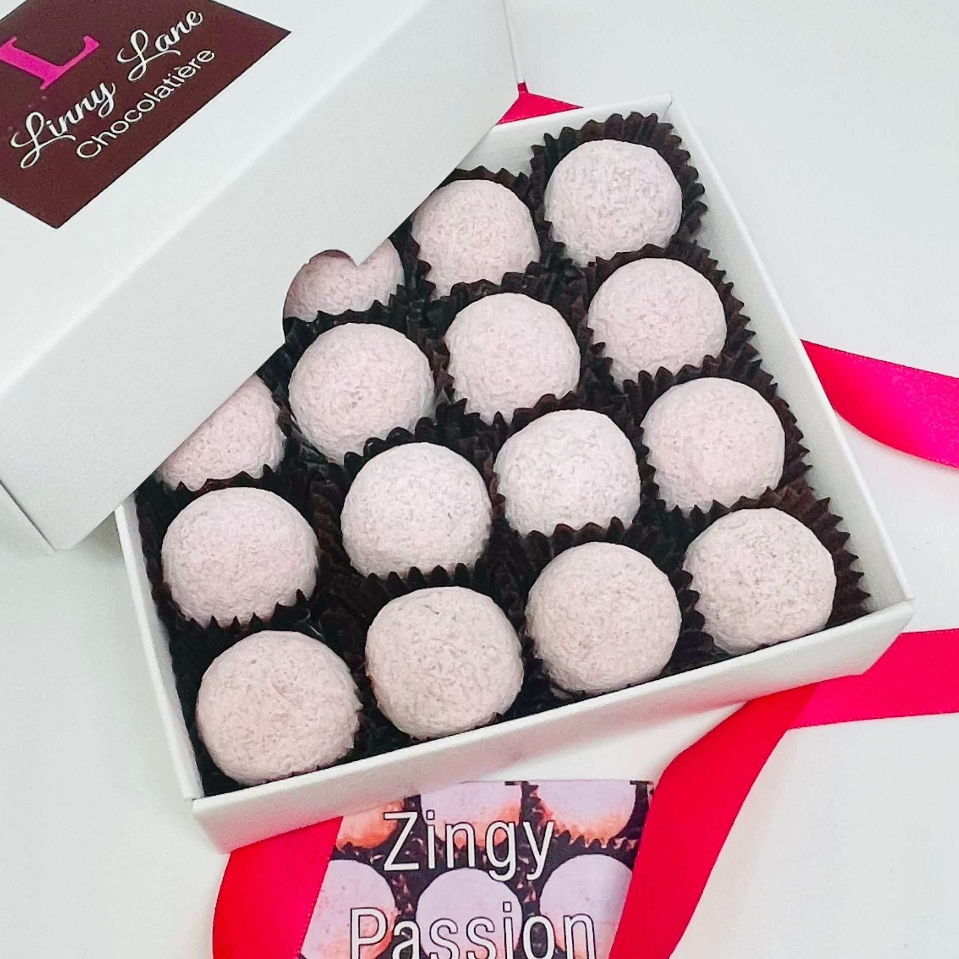 Zingy passion fruit Truffles, encased in white chocolate and dusted with raspberry sugar. 
