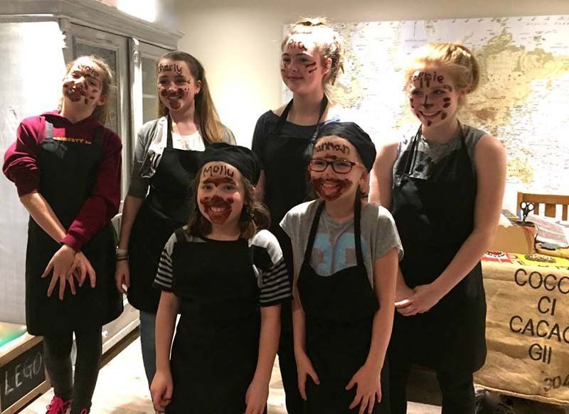 woman and girls with chocolate on their faces