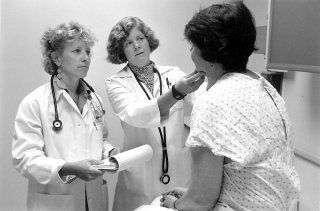 Woman Being Check by Two Doctors — Tampa, FL — Gegan Law Office