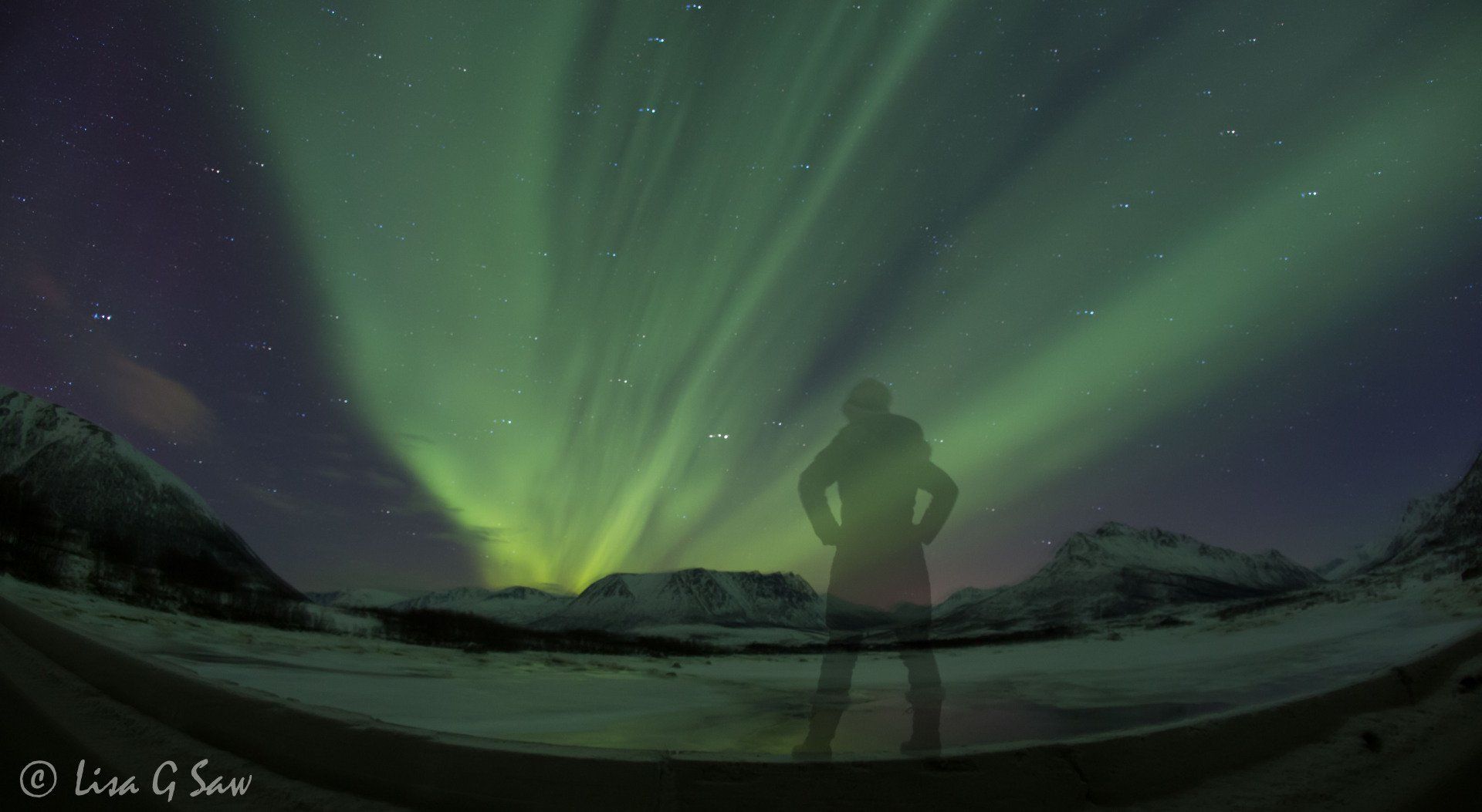 Northern Lights and person standing on wall, Norway