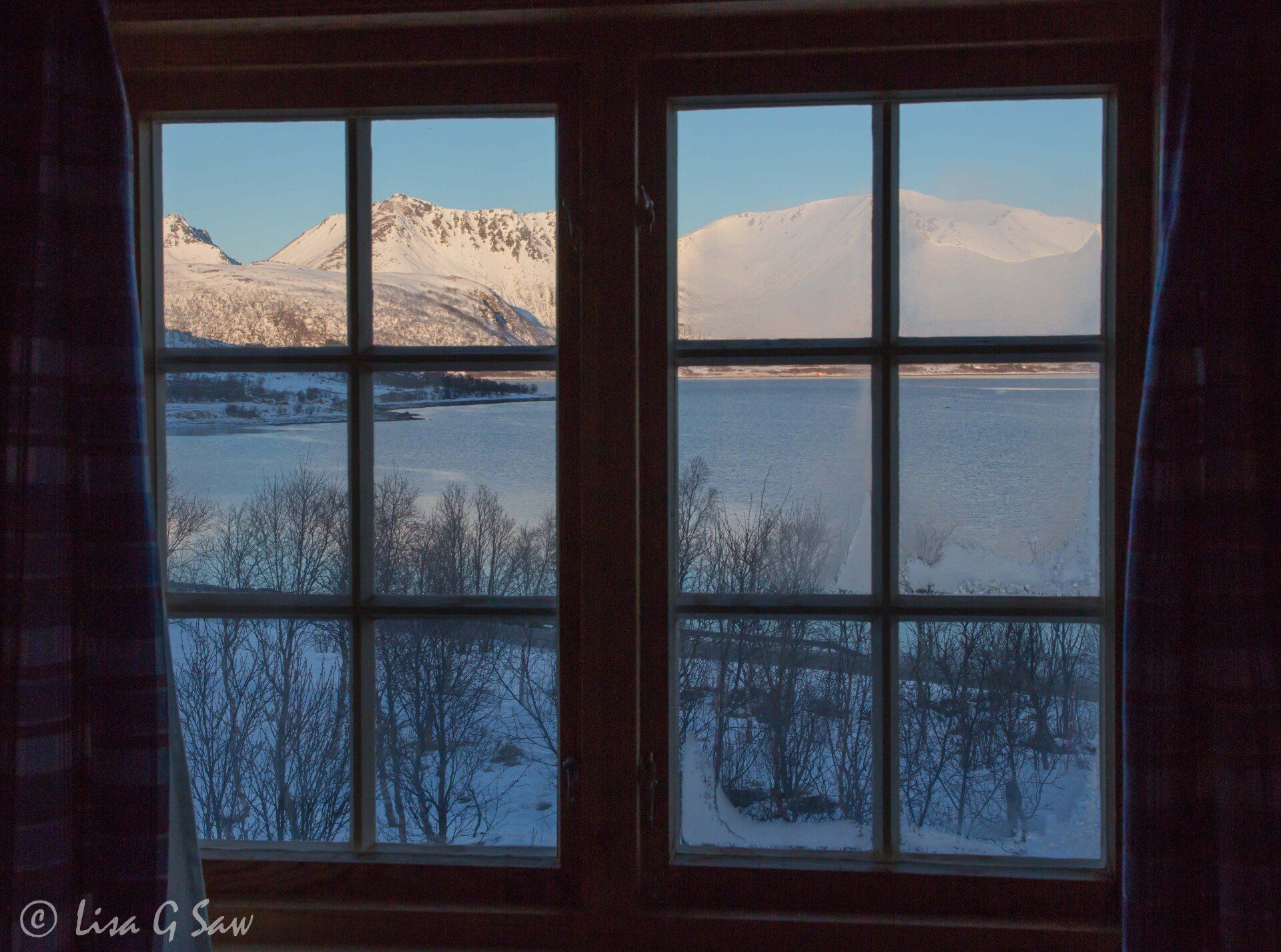 View of snow covered mountains from inside cabin