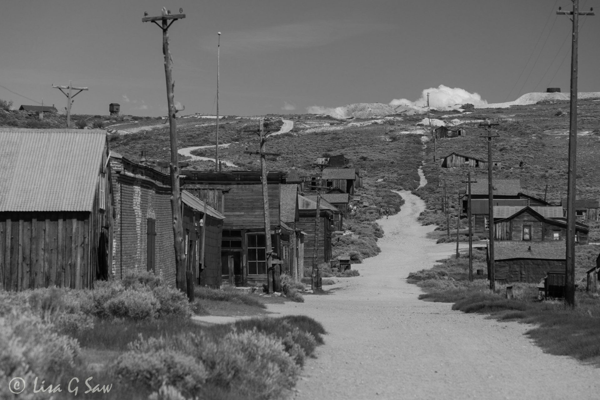 Derelict buildings and empty gravel road in ghost town, Bodie (black and white) (black and white)
