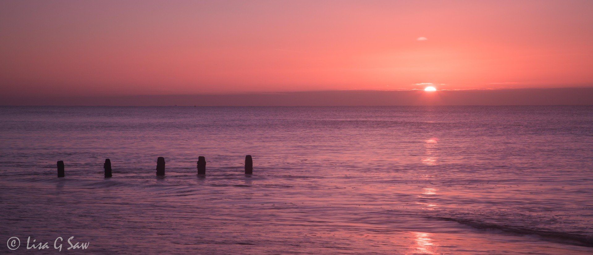 Sunrise over the sea and wooden posts, Worthing