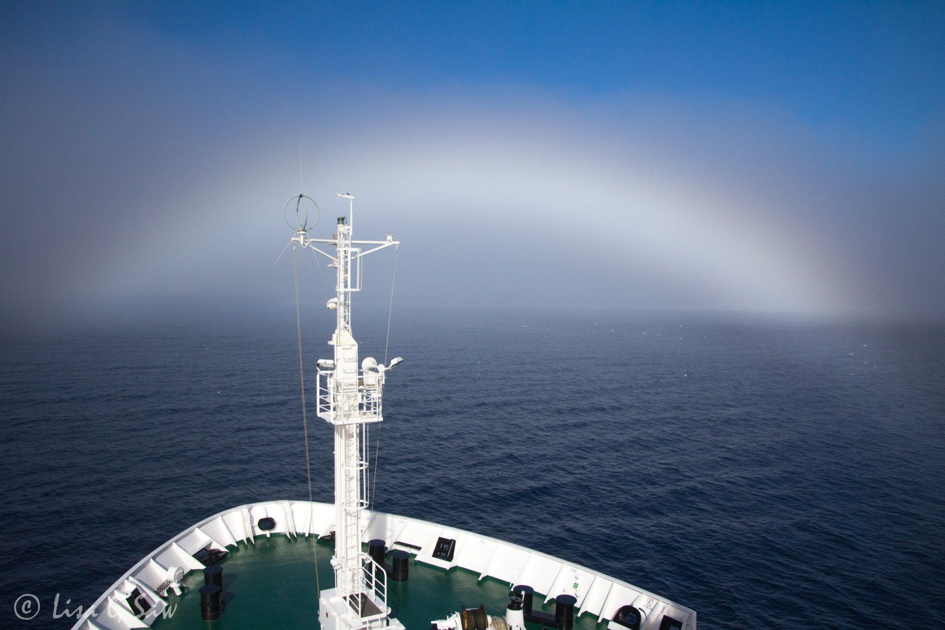 Fog bow over bow of ship
