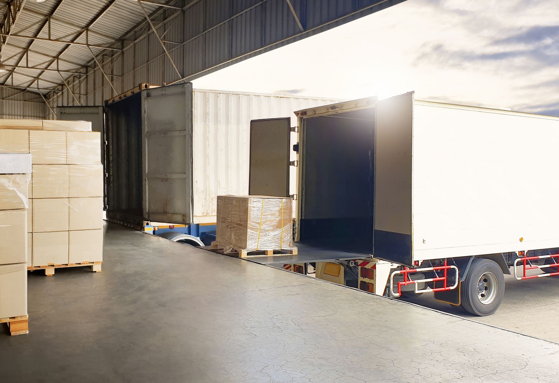 A truck is loading boxes into a warehouse.