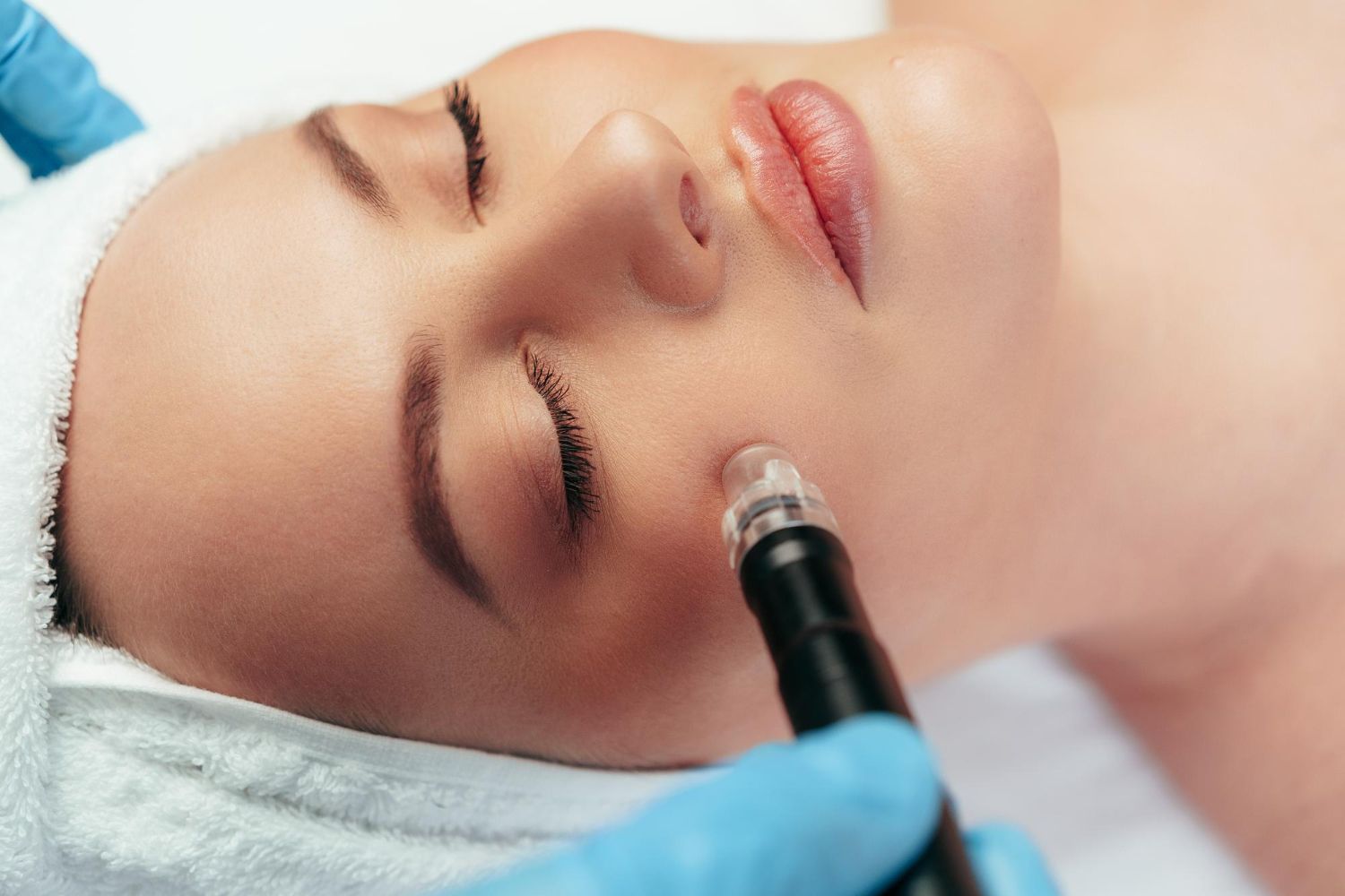 A woman is getting a facial treatment at a spa.