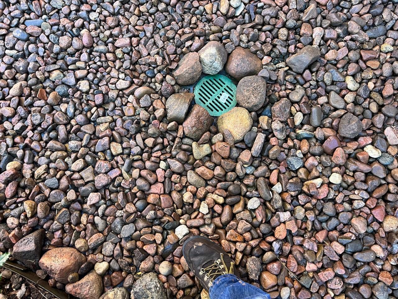 A pile of rocks with a green stone in the middle.