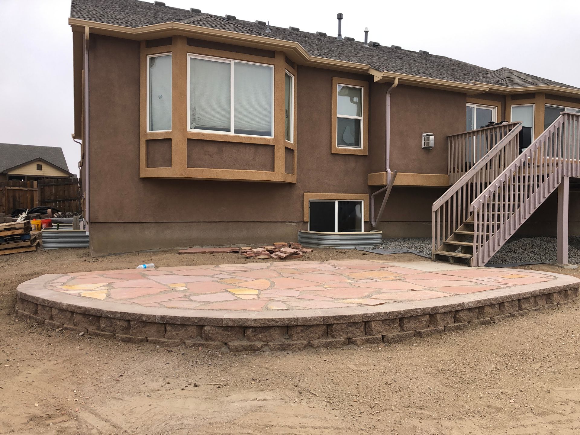 A house with a patio and stairs in front of it