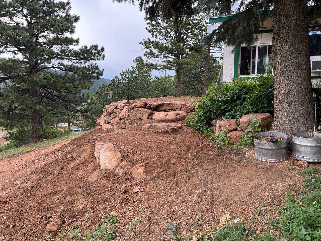A large pile of dirt is sitting in front of a house.